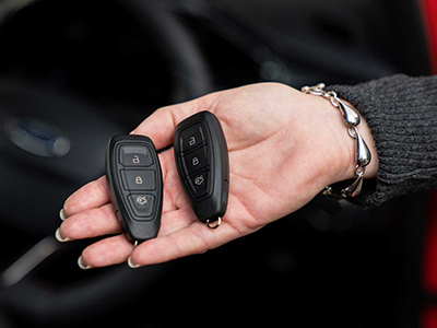 Technician reprogramming a Ford key fob on-site